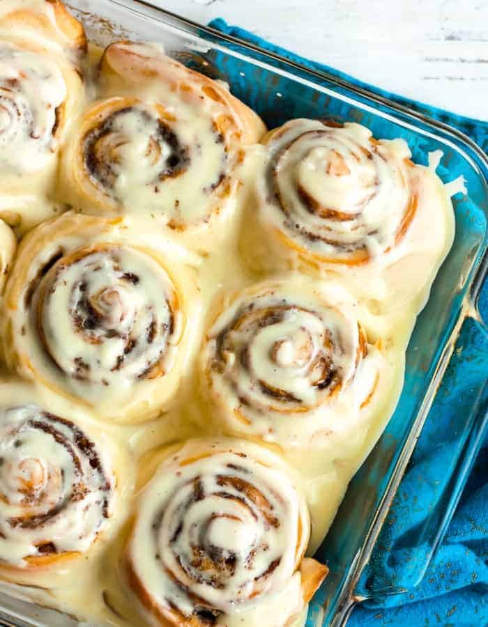 A tray of overnight cinnamon rolls covered in frosting