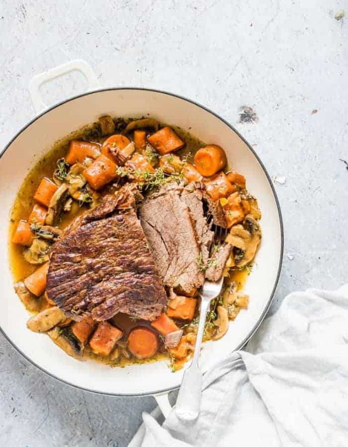 21 easy, healthy, and compliant Whole30 dinners that you'll actually want to eat week after week. 21 delicious quick recipes that can be made in the Instant Pot, crockpot, or stovetop. #whole30 #whole30dinners #paleodinners instant pot pot roast in a white pan for whole30 dinners