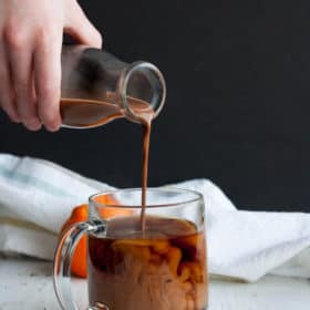 a pour shot showing chocolate coconut coffee creamer into a mug of coffee