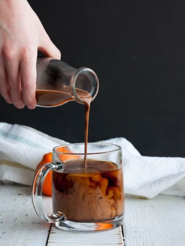 a pour shot showing chocolate coconut coffee creamer into a mug of coffee