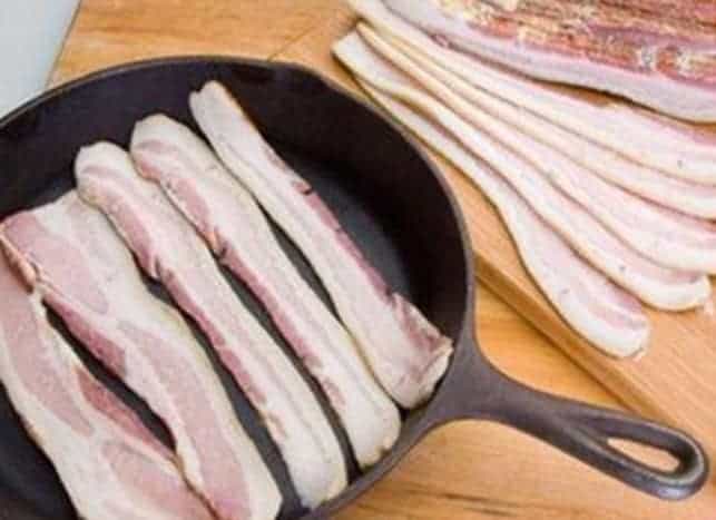 us wellness whole30 bacon in a cast iron skillet