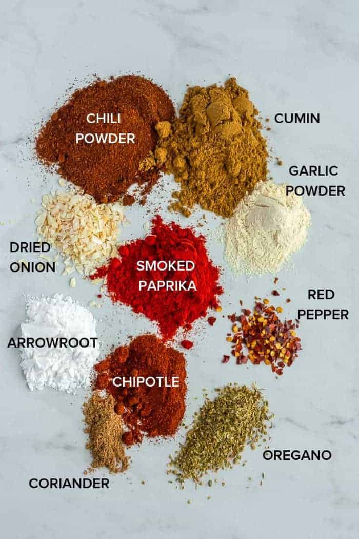 piles of spices and herbs to make paleo taco seasoning