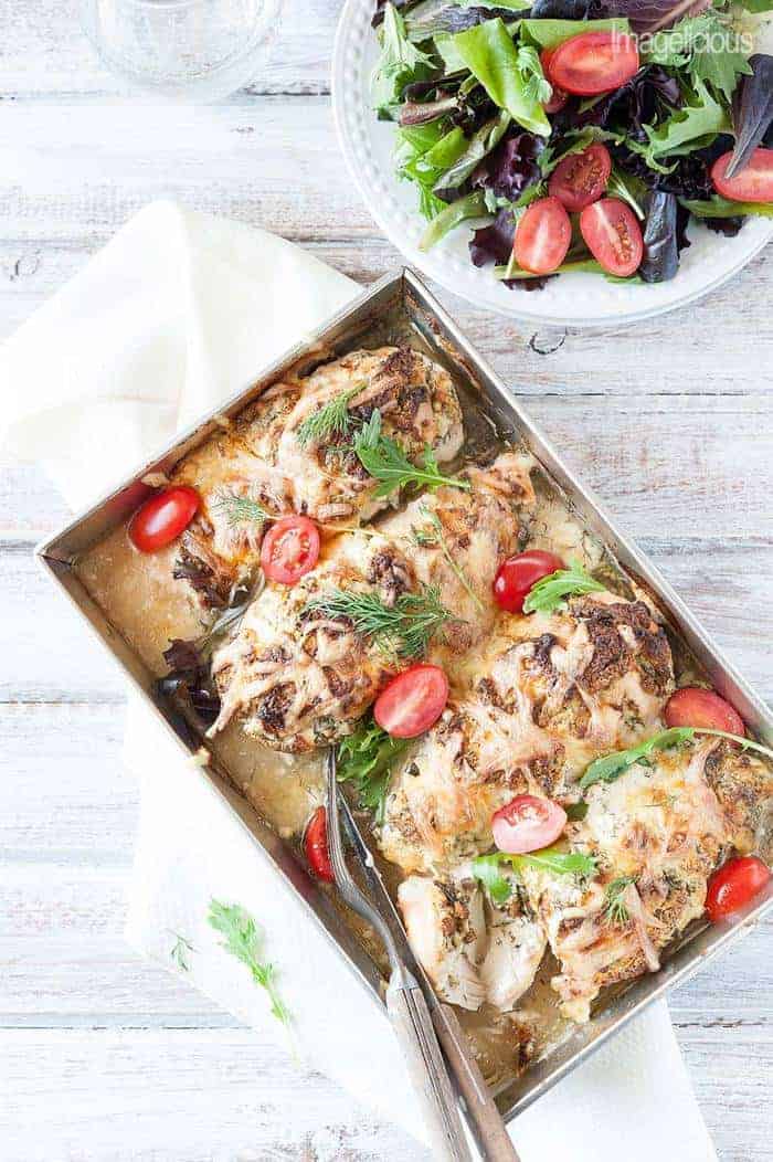 a baking dish of easy stuffed chicken breasts with tomatoes and greens