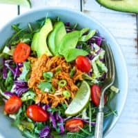 whole30 pressure cooker chicken tacos on a salad in a bowl with a fork