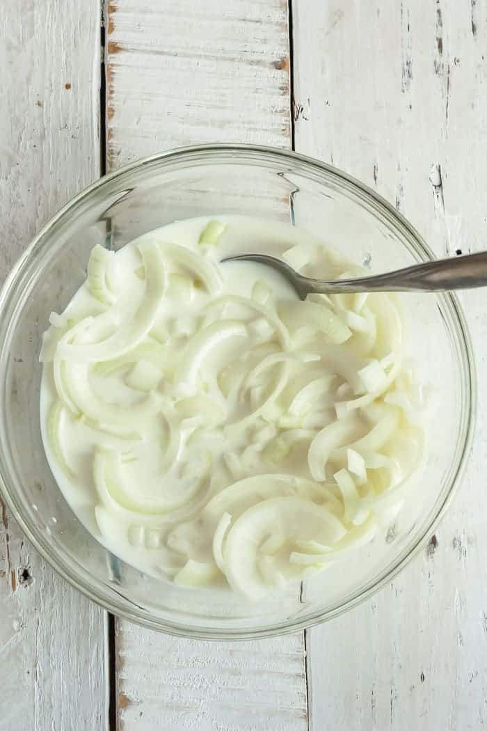 sliced onions in a bowl with milk