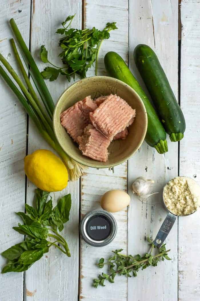 Ground turkey, zucchini, a lemon and other ingredients for making baked turkey meatballs