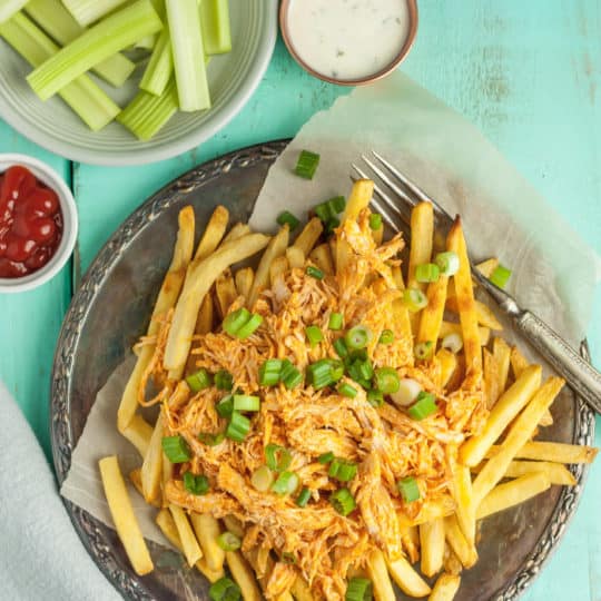 A plate of buffalo chicken fries with celery sticks and dip
