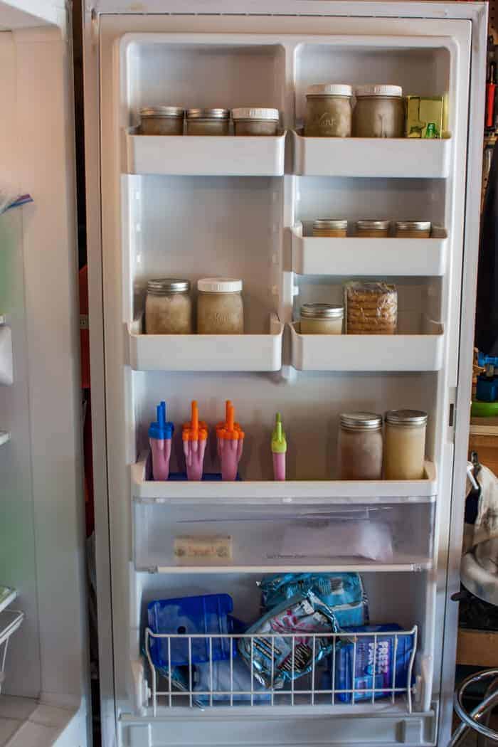 a stand up freezer door with canning jars
