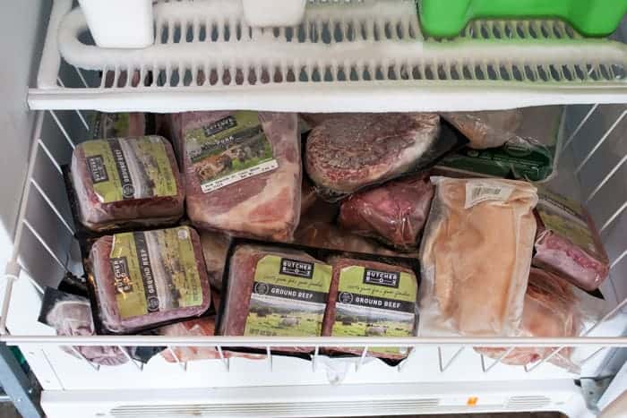 a freezer drawer with frozen meat