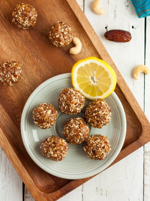 a plate of lemon bliss balls with cashews and almonds