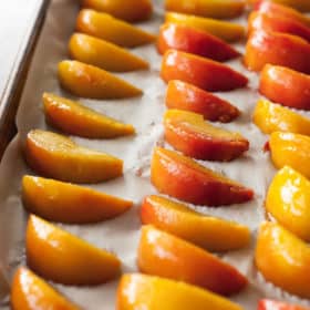 frozen peach slices on a baking tray