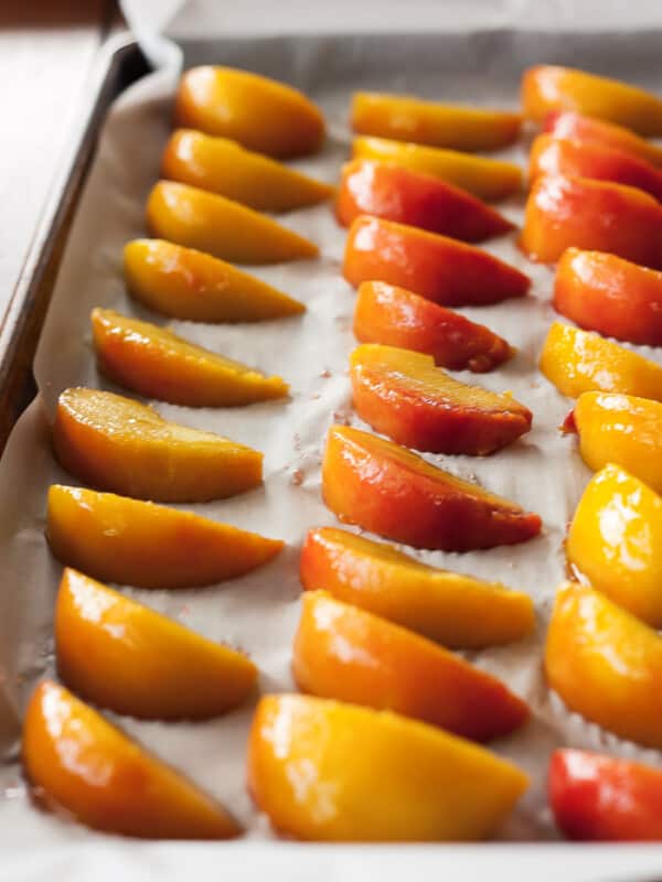 frozen peach slices on a baking tray