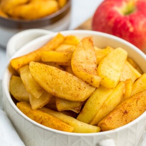 a white bowl with cinnamon apple slices