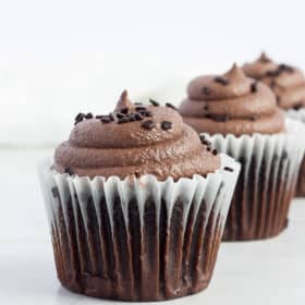 three chocolate cupcakes with espresso buttercream frosting