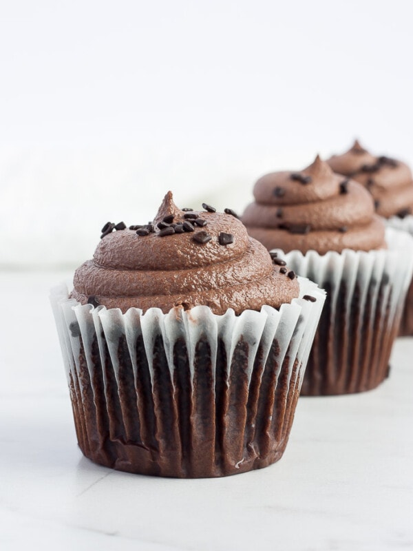three chocolate cupcakes with espresso buttercream frosting