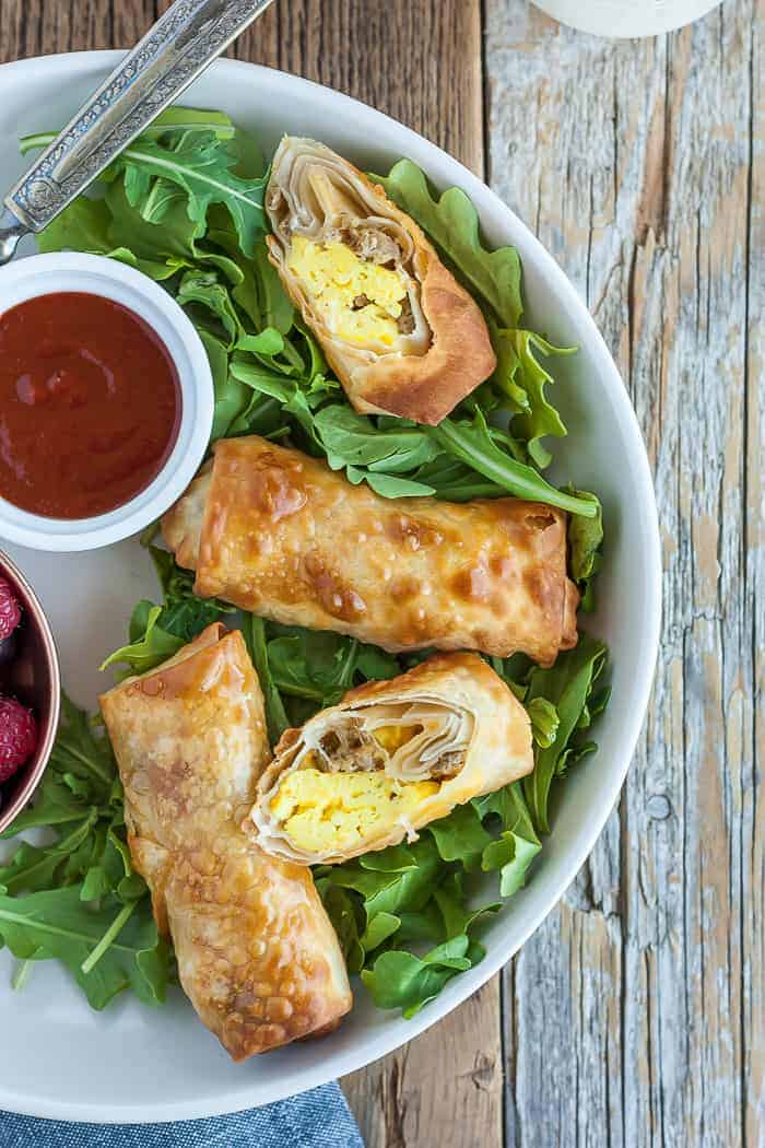 bacon and egg rolls on a bed of greens with salsa