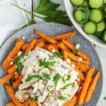a plate of greek fries with sliced cucumbers