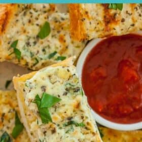 a plate of garlic cream cheese bread with a bowl of marinara dipping sauce
