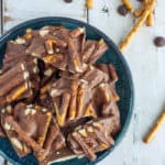 pretzel bark on a blue plate on a white board.