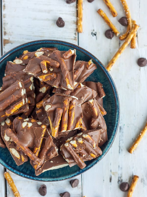 pretzel bark on a blue plate on a white board.