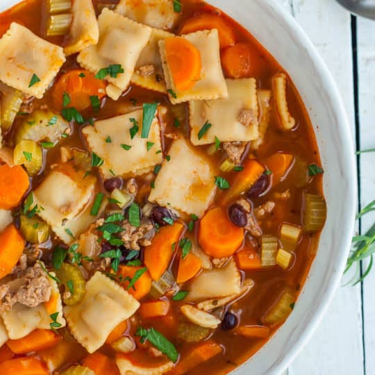 a bowl of Instant Pot Vegetable Noodle Soup topped with diced parsley