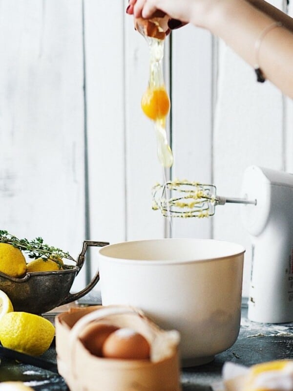 A hand cracking an egg and cooking