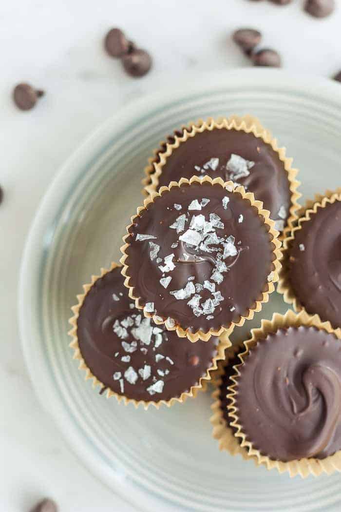 paleo almond butter cups topped with sea salt on a plate