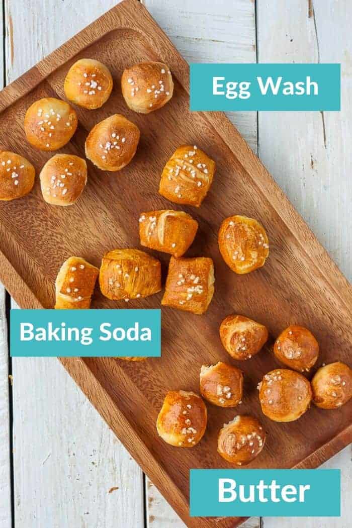 soft pretzel bites on a wooden tray with 3 labels - butter, baking soda, and egg wash