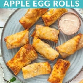 Apple Pie Egg Rolls on a grey plate with a small bowl of greek yogurt dipping sauce