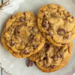 an upclose photo of 3 air fryer chocolate chip cookies on a beige plate