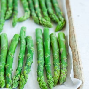 A baking tray with frozen asparagus