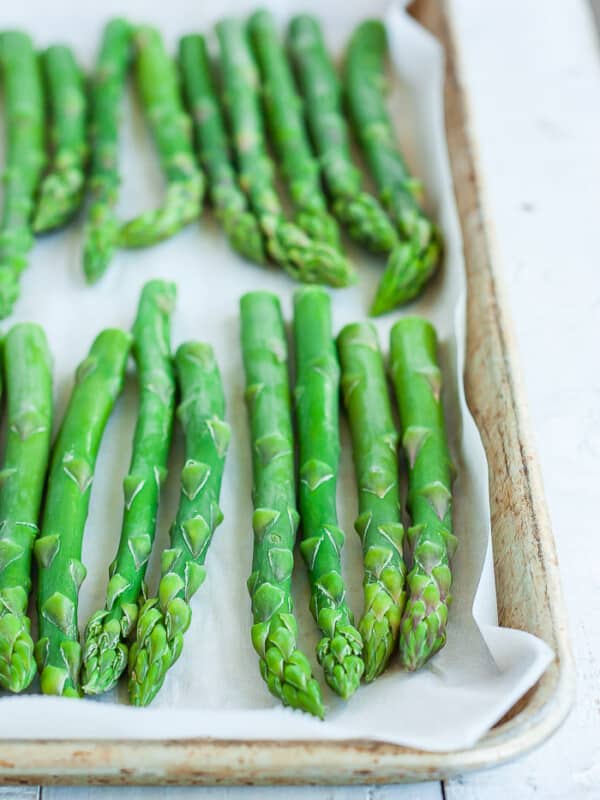 A baking tray with frozen asparagus