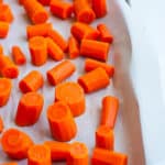 a baking sheet lined with chopped carrots