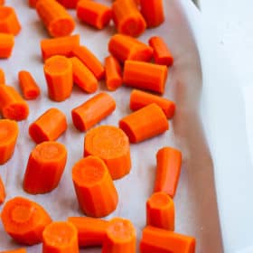 a baking sheet lined with chopped carrots