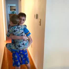 a boy carrying his younger brother