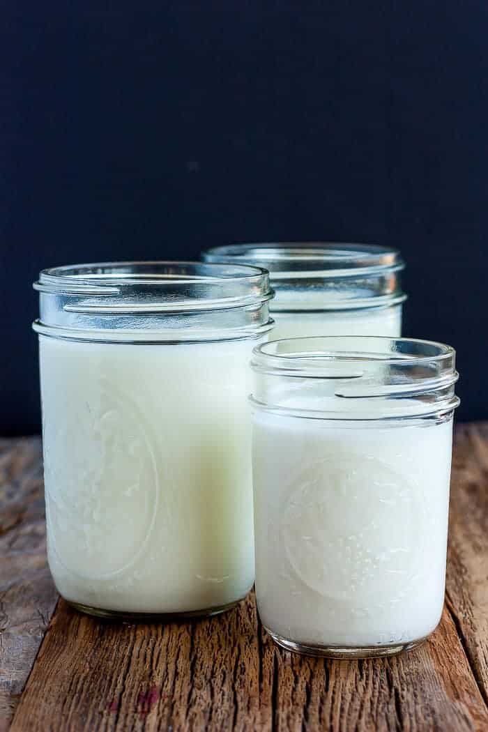3 jars of buttermilk on a wooden board