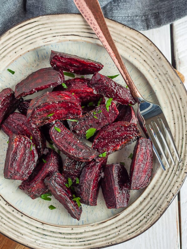 Air fryer roasted beets on a tan plate with a fork