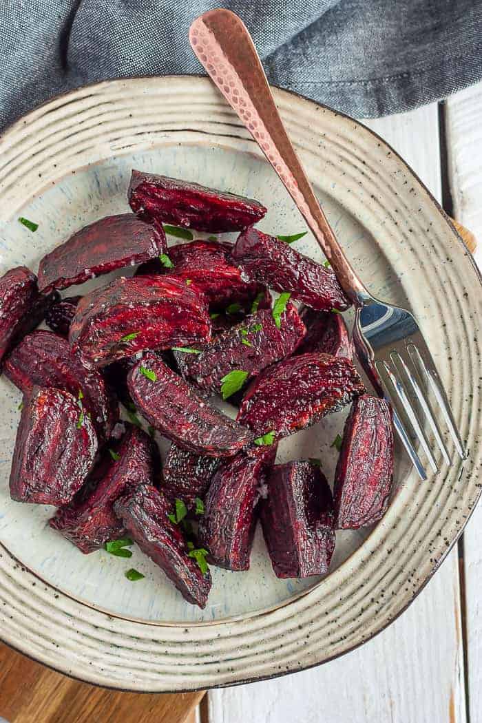 Air fryer roasted beets on a tan plate with a fork