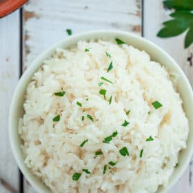 A bowl of rice topped with parsley