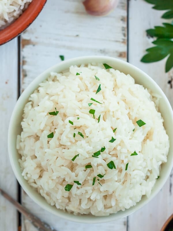 A bowl of rice topped with parsley