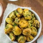 fried okra in a white dish on a wooden plate