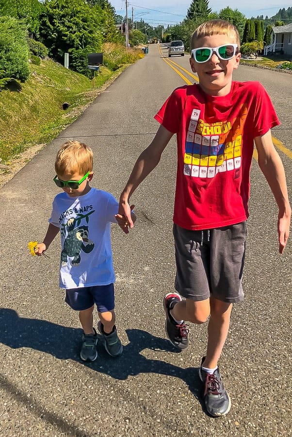 2 boys walking and holding hands