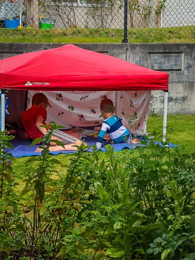 2 kids in a red tent