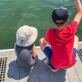 2 boys fishing on a dock
