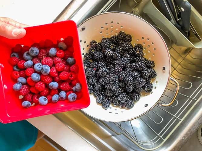 2 containers of berries in a sink