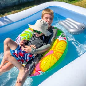 2 boys in a blow up swimming pool