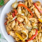 a white bowl of chicken fajitas