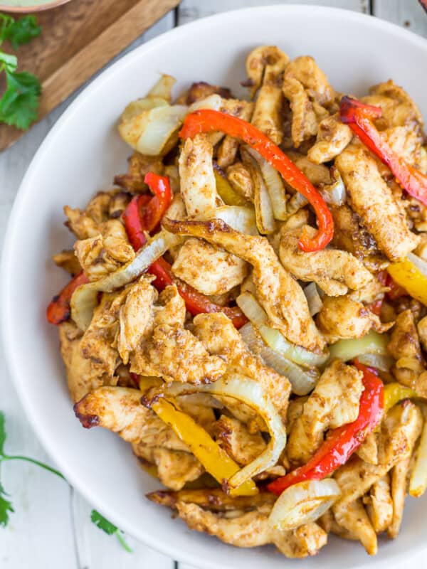 a white bowl of chicken fajitas