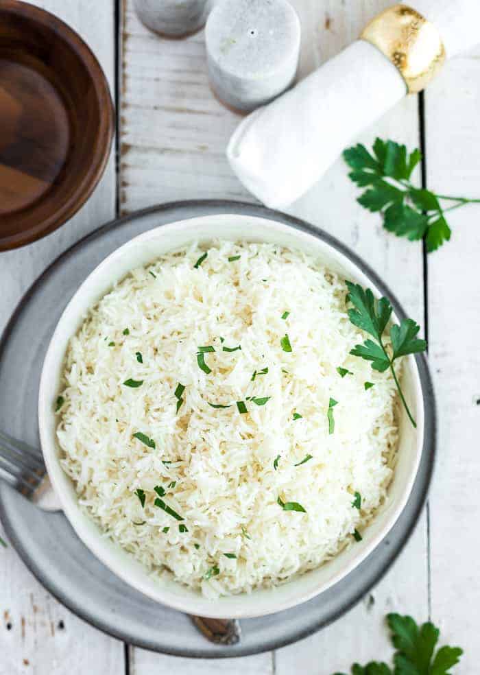 a bowl of basmati rice topped with parsley