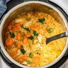 an Instant Pot full of gnocchi soup with a ladle.